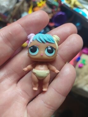 an L.O.L. Surprise! Lil Bon Bon collectible baby doll figure
